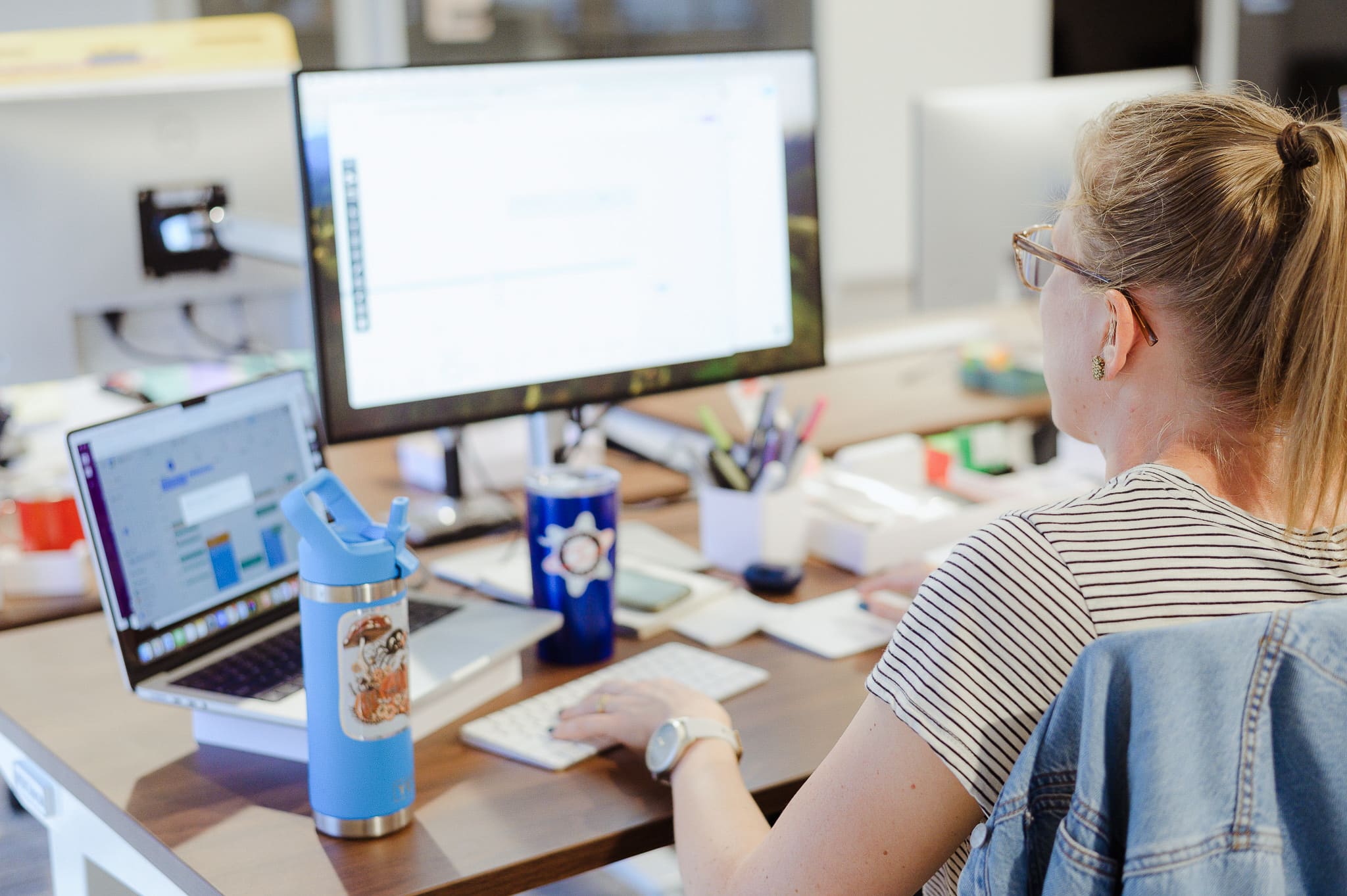 A developer codes at her desk. Post title: AI This, Optimise That – But What Does Coding With It Actually Look Like?
