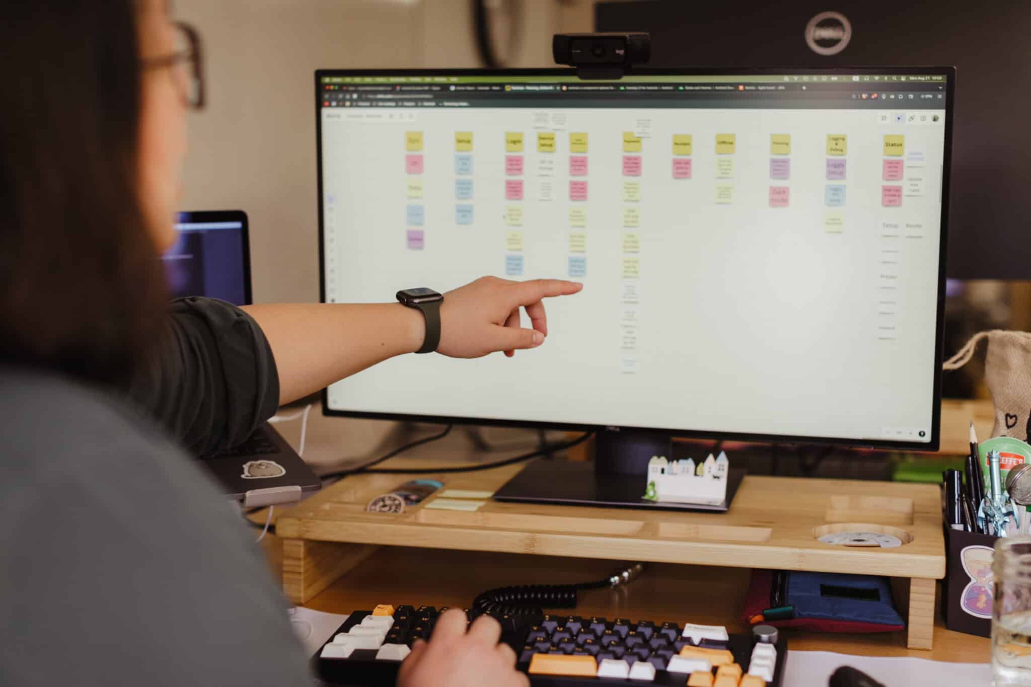 Author Jing Fan points at a monitor. Post title: Grep Is 10,000x Faster Than Your Eyeballs — But You Can Still See