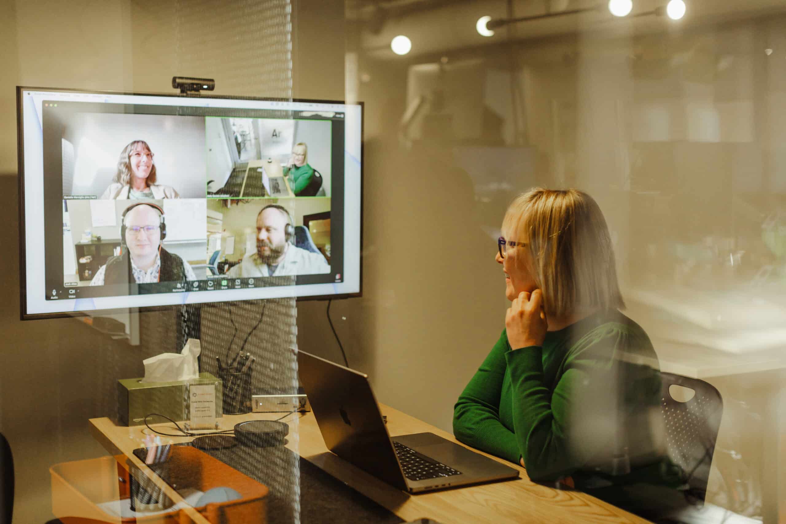 Pictured are Atomic Object Ann Arbor employees on a remote video call. Post title: Making Remote Work Human: Building Culture from a Distance