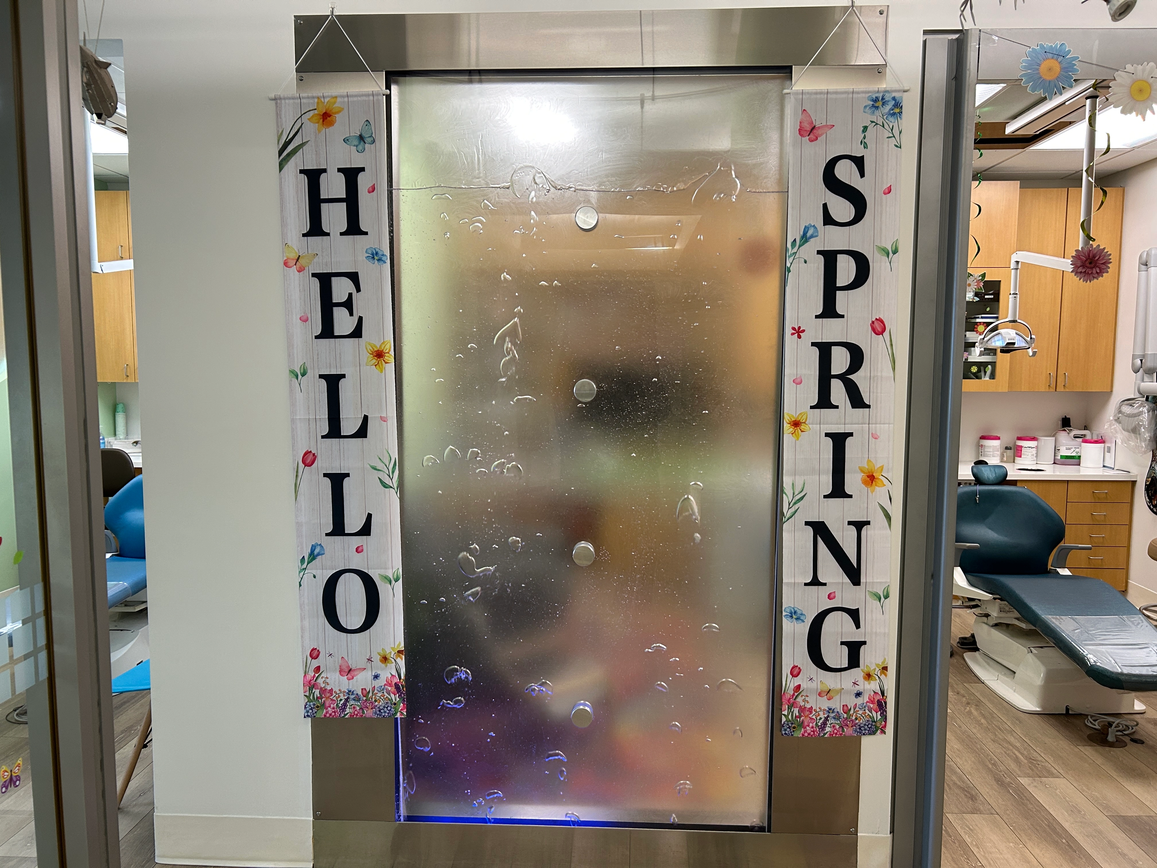 Spring-themed office decor between pediatric dental treatment rooms at Kidz Place Dentistry in San Diego, CA.