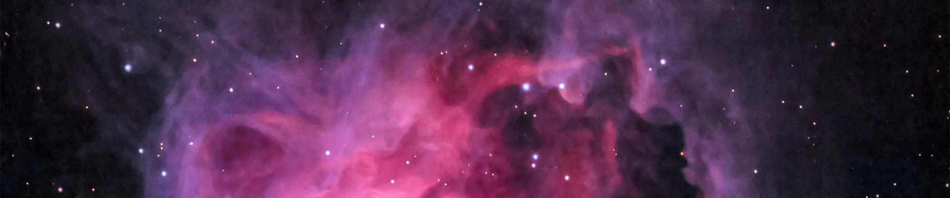 A pink nebula in space.