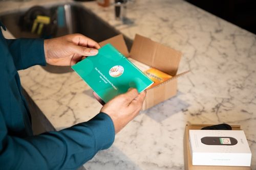 Person opens a box with Nicotine Replacement Therapy (NRT)