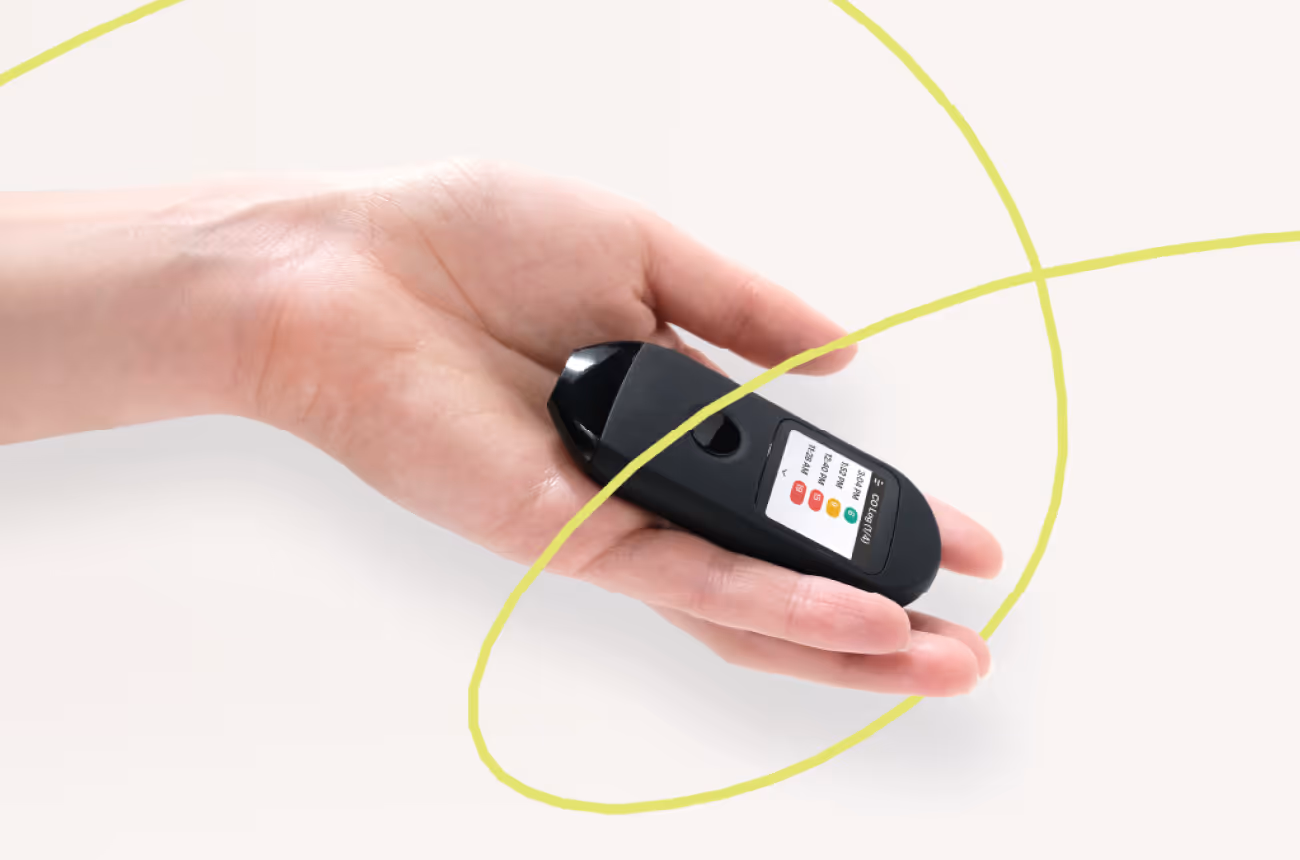 Person holding Pivot Breath Sensor with swirly line