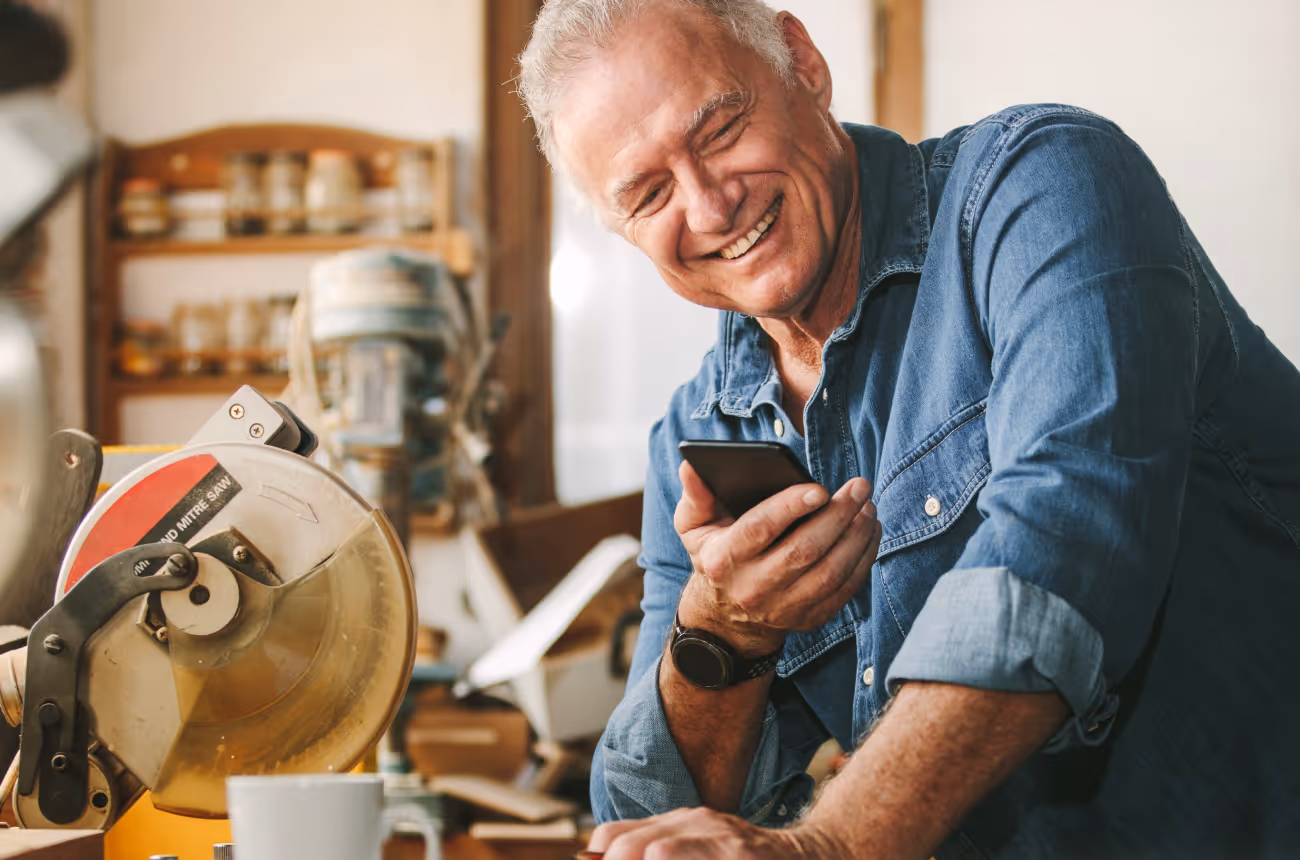 Older man holding phone