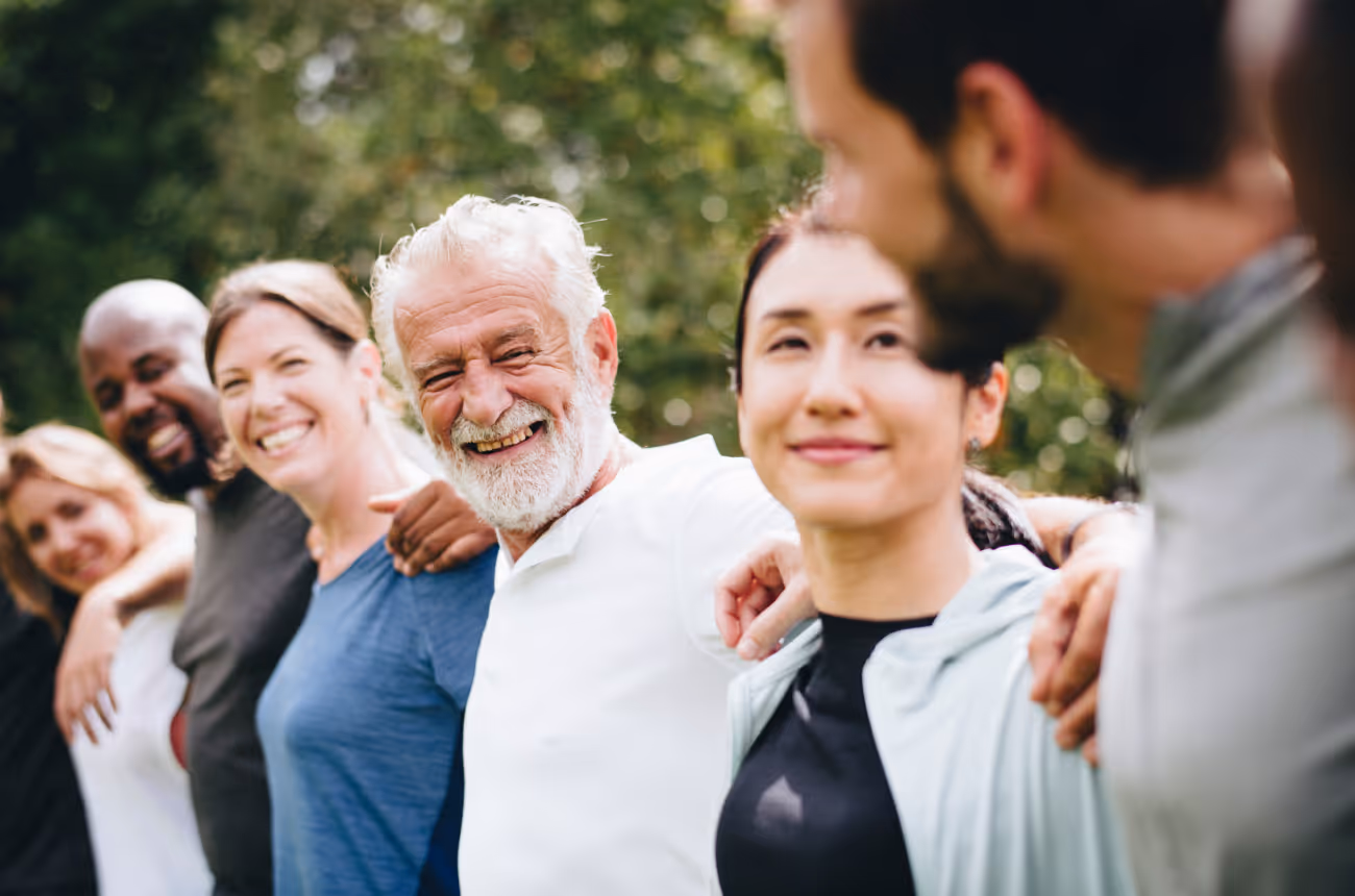 Group of people with arms around each other