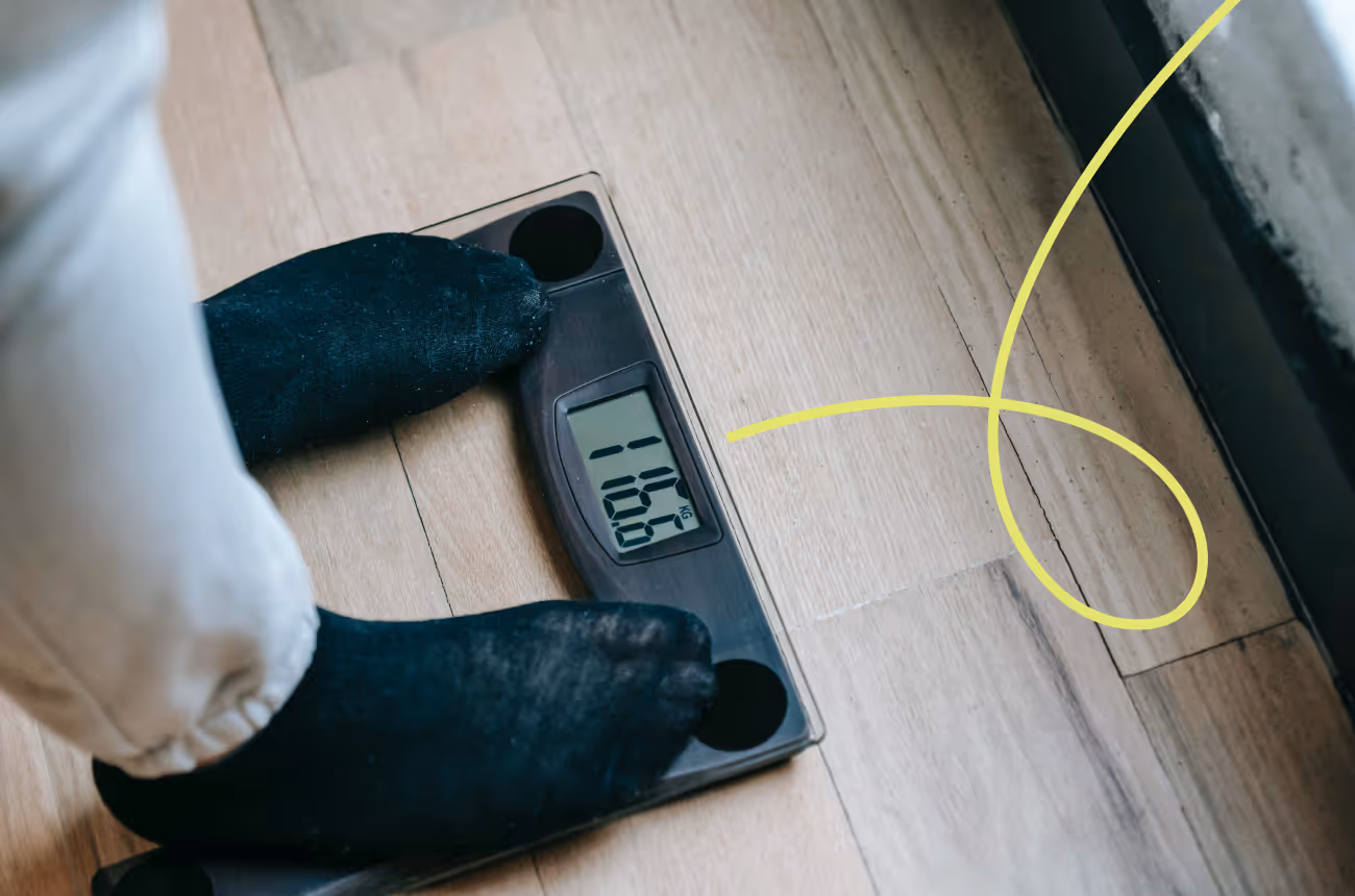 feet standing on a scale in socks