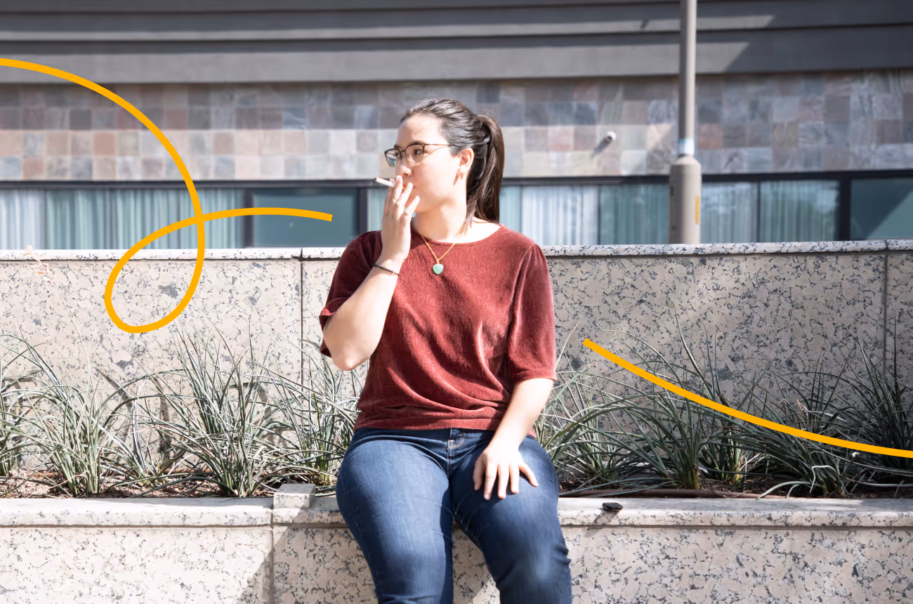 woman sitting on a bench smoking a cigarette