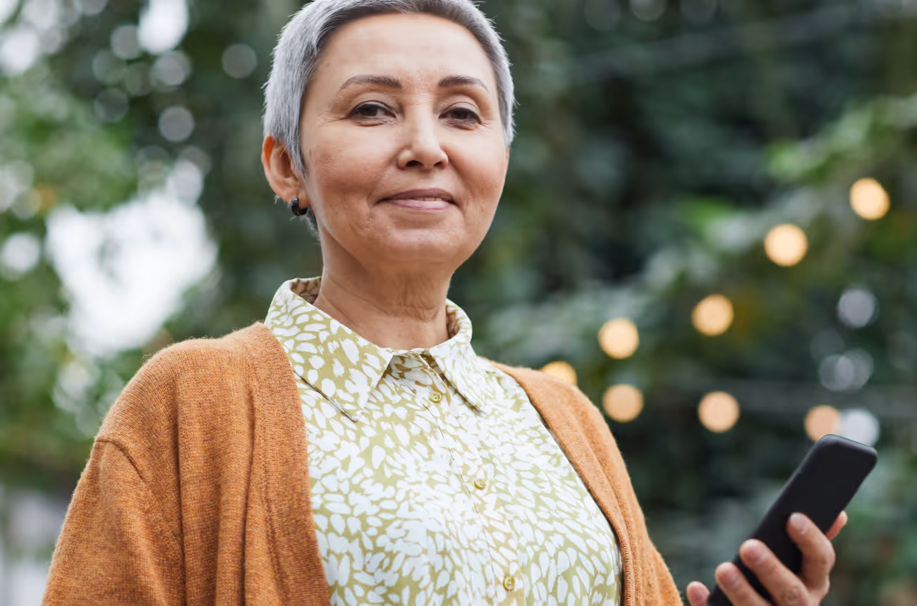 Woman with short grey hair looking at camera and smiling