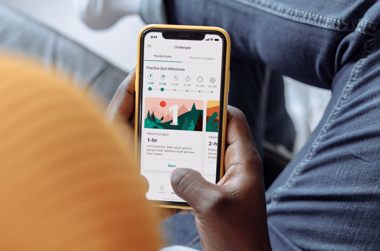 Man with beanie on looking at phone with Pivot homepage