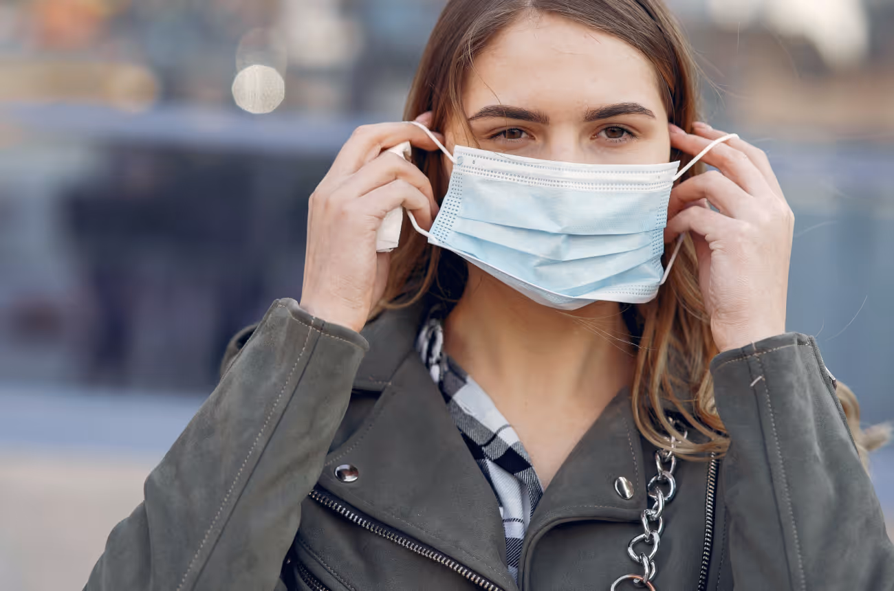 Woman putting on a mask