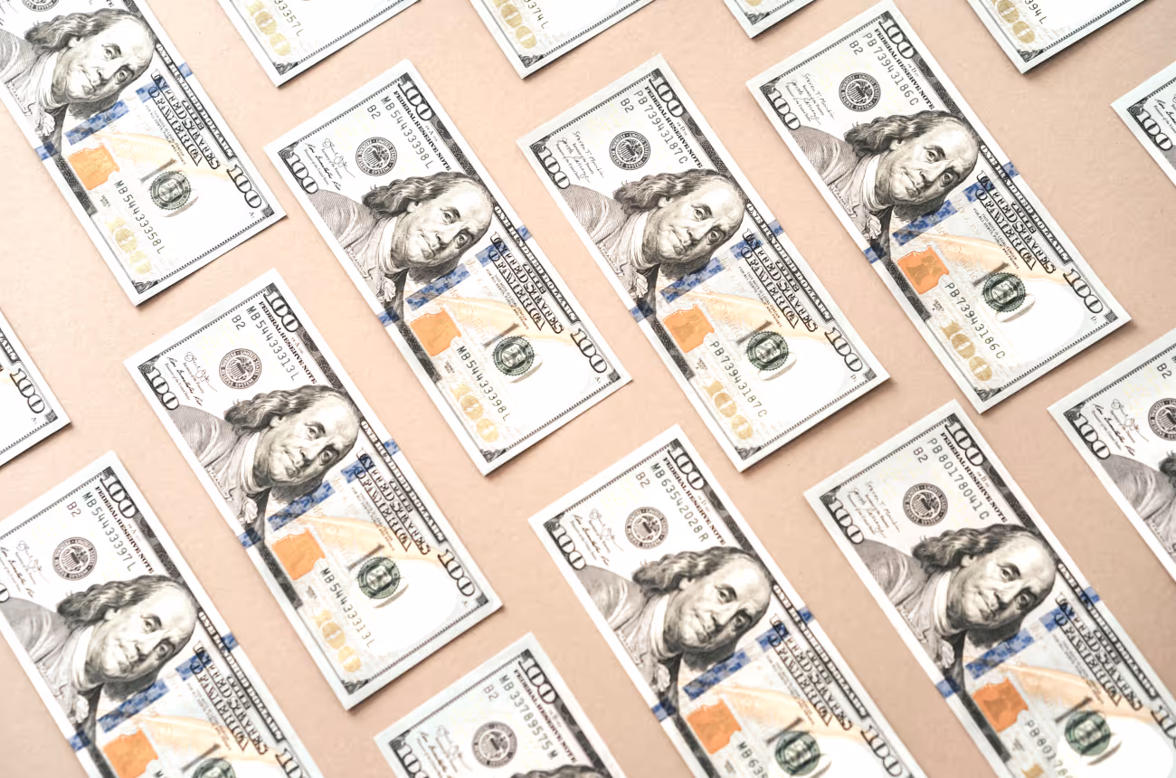 hundred dollar bills laid out flat, face side up 