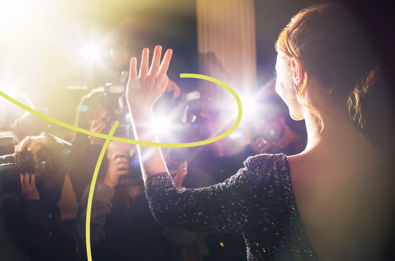 movie star waves to paparazzi