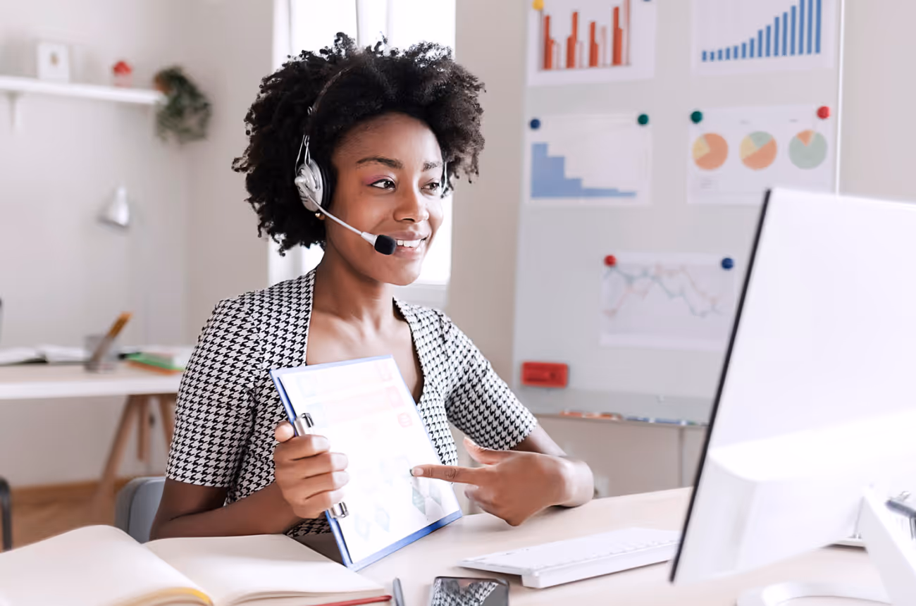 Woman sitting at a computer and smiling