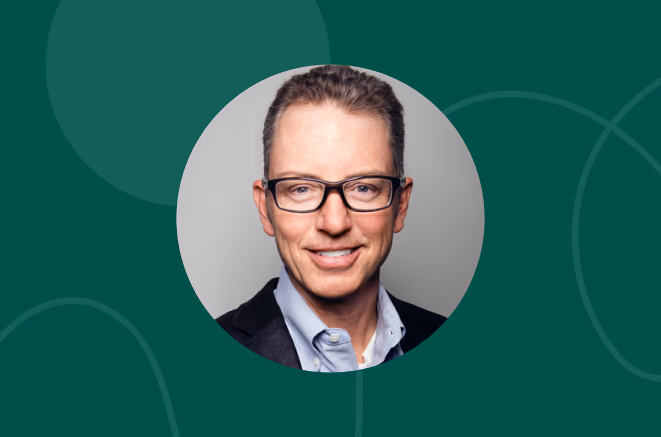 headshot of man on green background