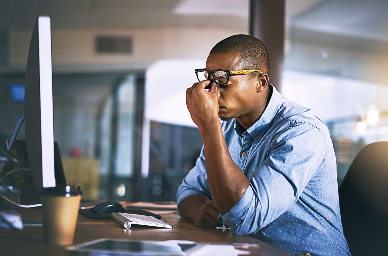 Employee stressed out with head in hands
