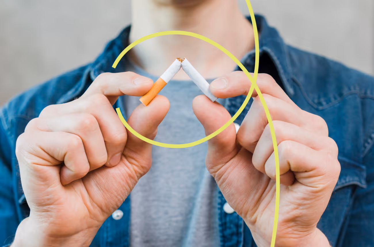 man breaking cigarette in half