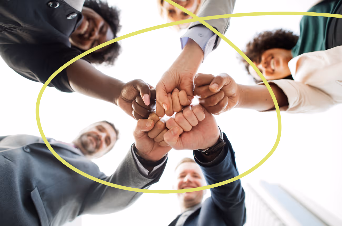 people holding their hands into the middle of a circle for a cheer