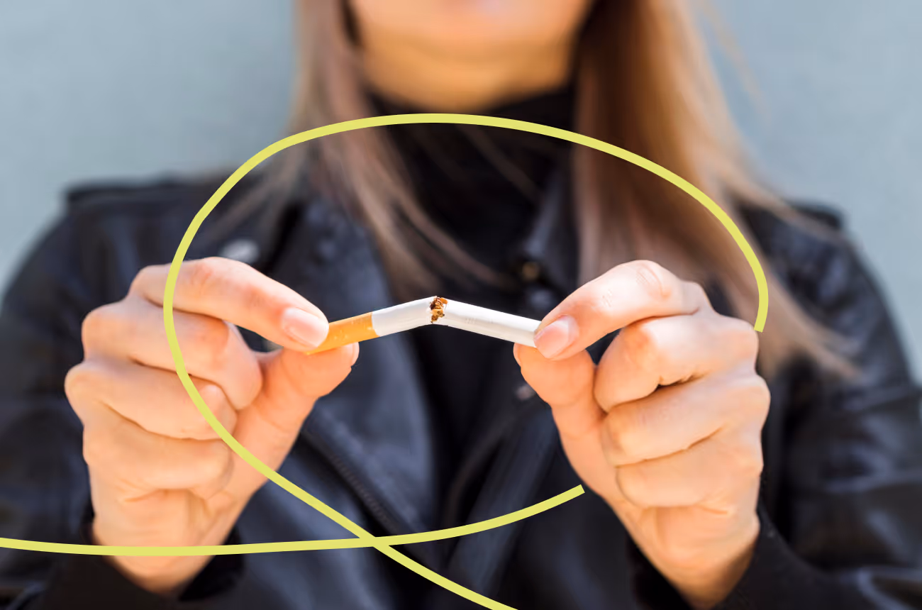 woman breaking cigarette in half