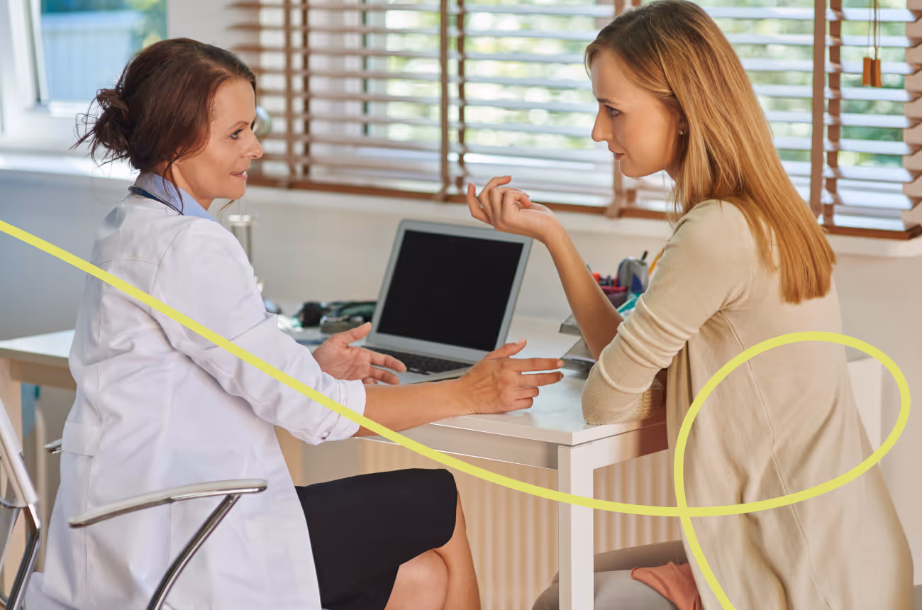 doctor speaking to patient at a desk