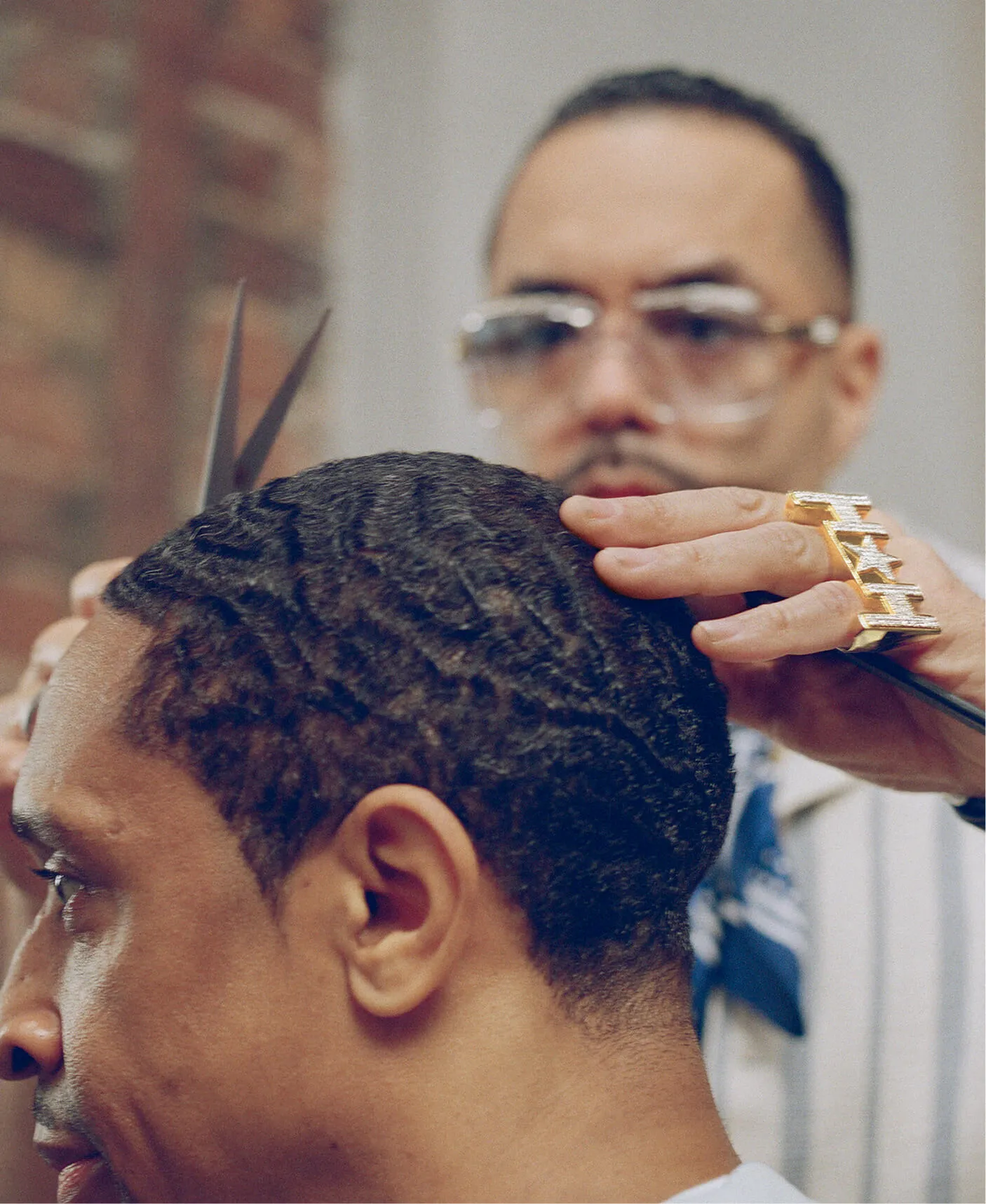 Closeup of barber styling man’s hair