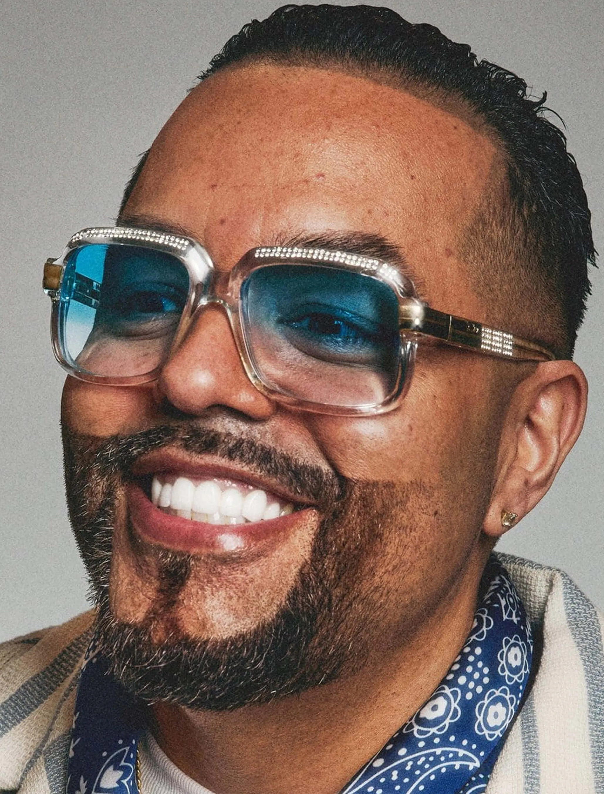 Closeup portrait of a professional barber wearing sunglasses with a manicured beard