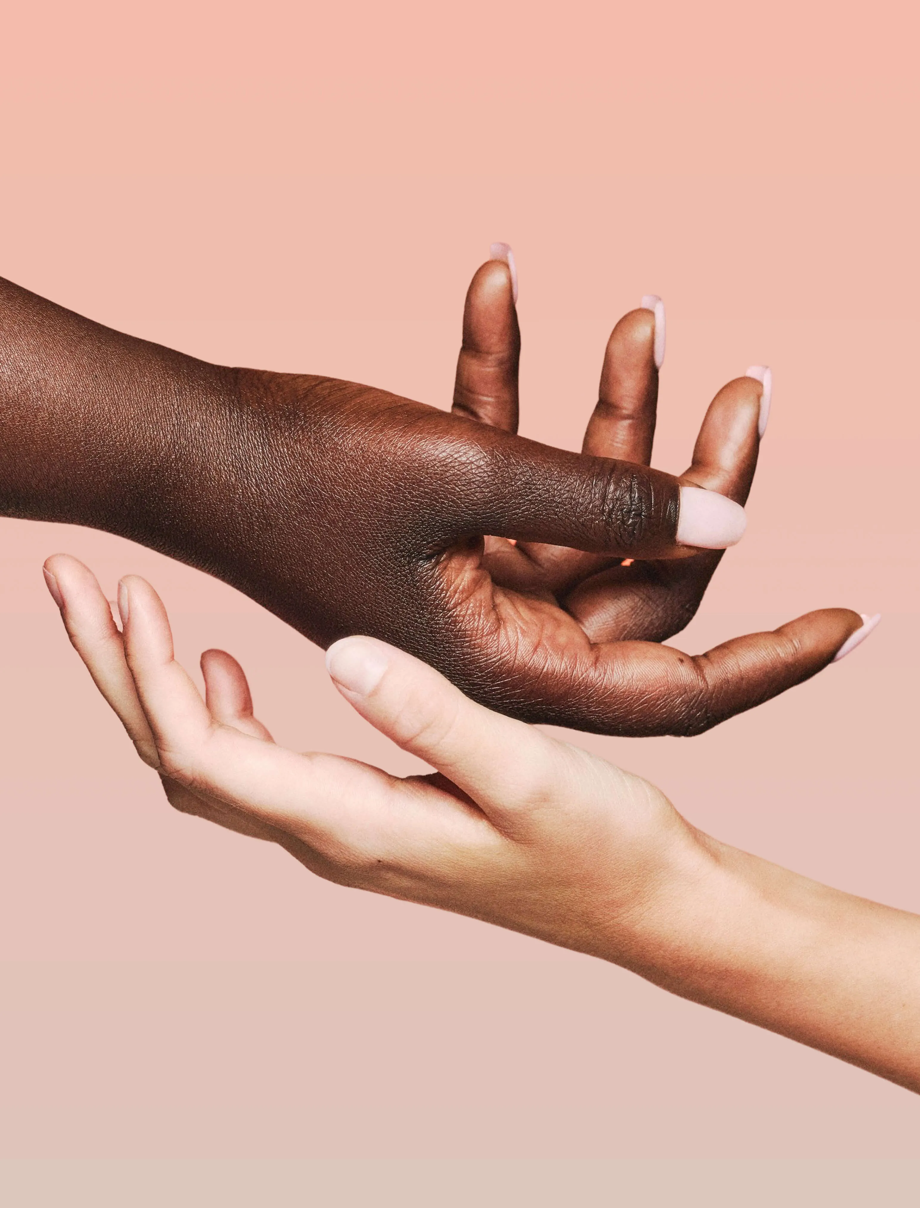 Two hands posed palms up, one hovering on top of the other