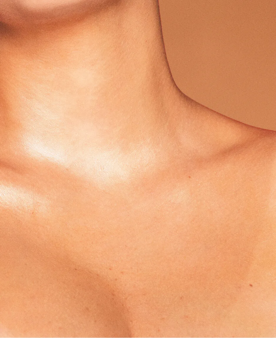View of a woman’s tanned neck, collarbone, and upper chest