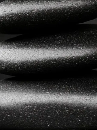 A closeup of three stacked hot stones