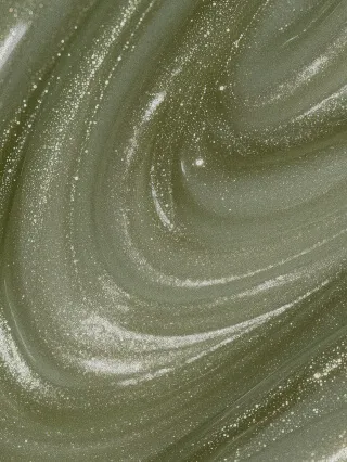 Closeup of a green, sparkly swirl pattern