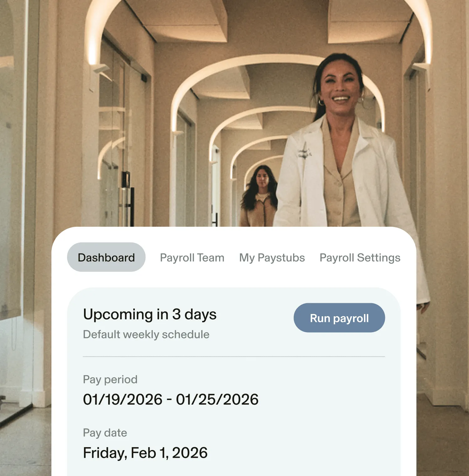 Image of a GlossGenius Payroll dashboard over a larger image of two women walking down a medspa hallway