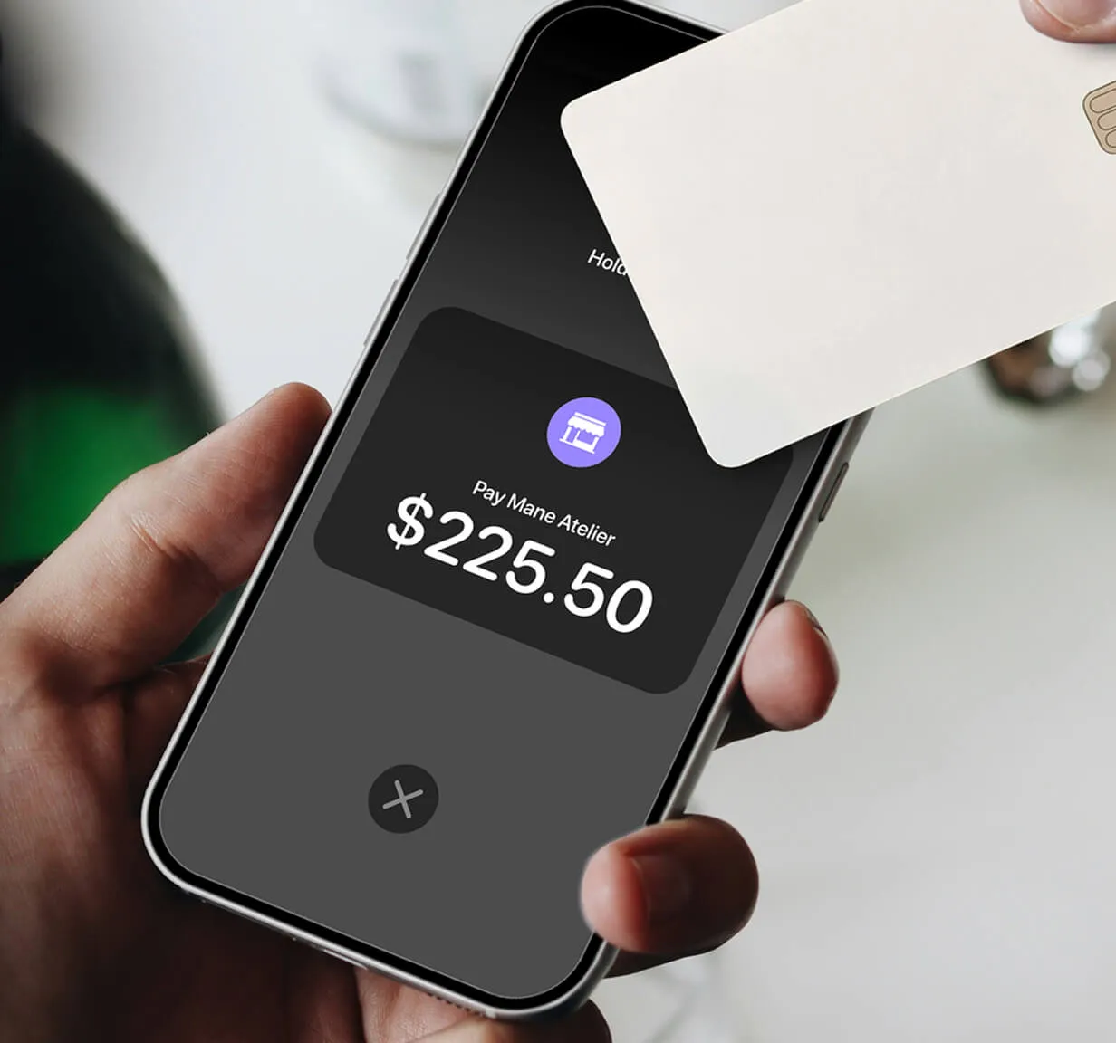 A card hovering over a mobile phone for Tap-to-Pay