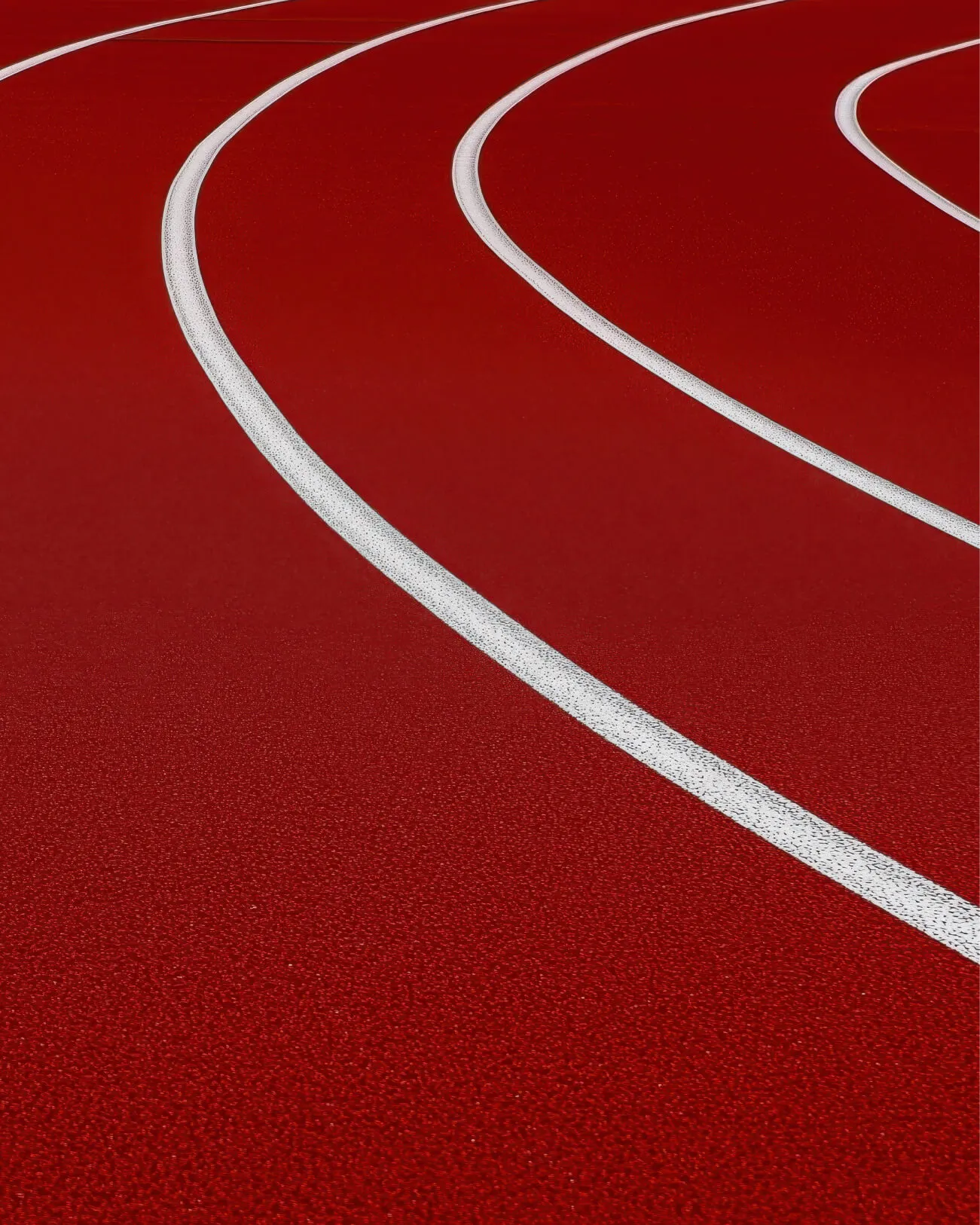 Close-up of a red athletic track corner.