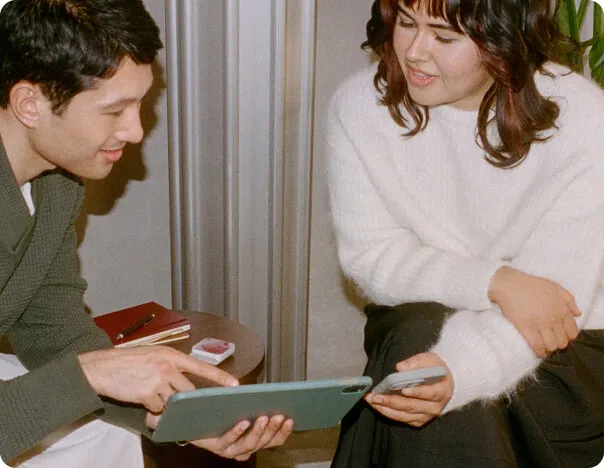 A man and a woman looking at a laptop screen.