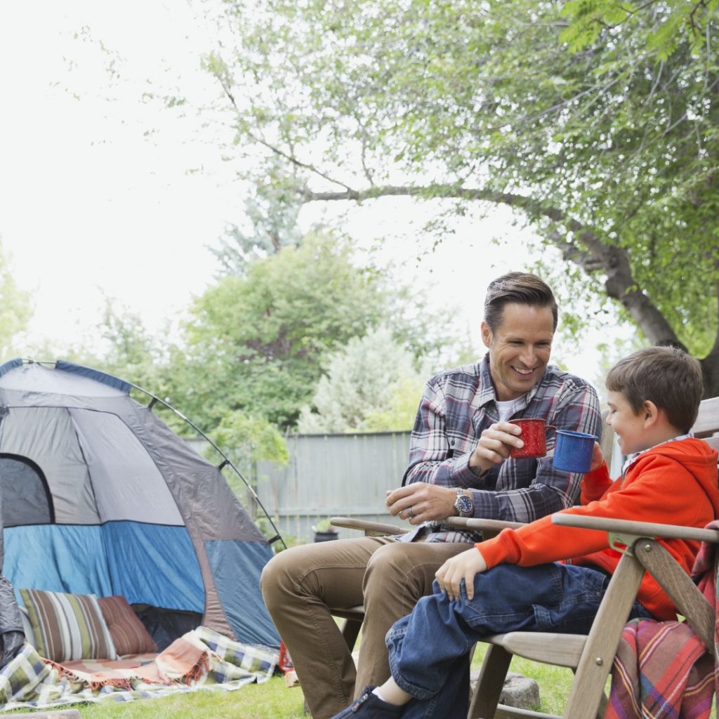 Father and son camp out in the backyard during the summer