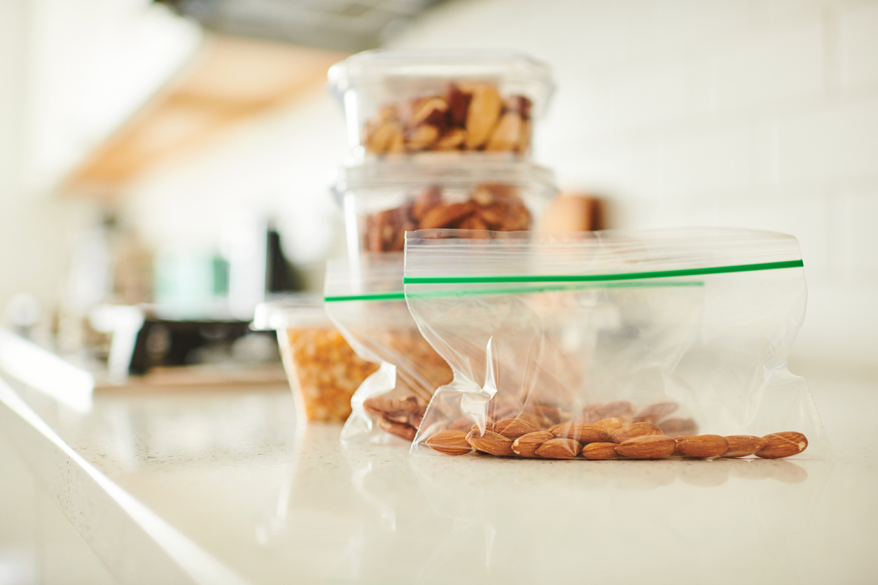 A plastic bag filled with nuts sitting on top of a counter