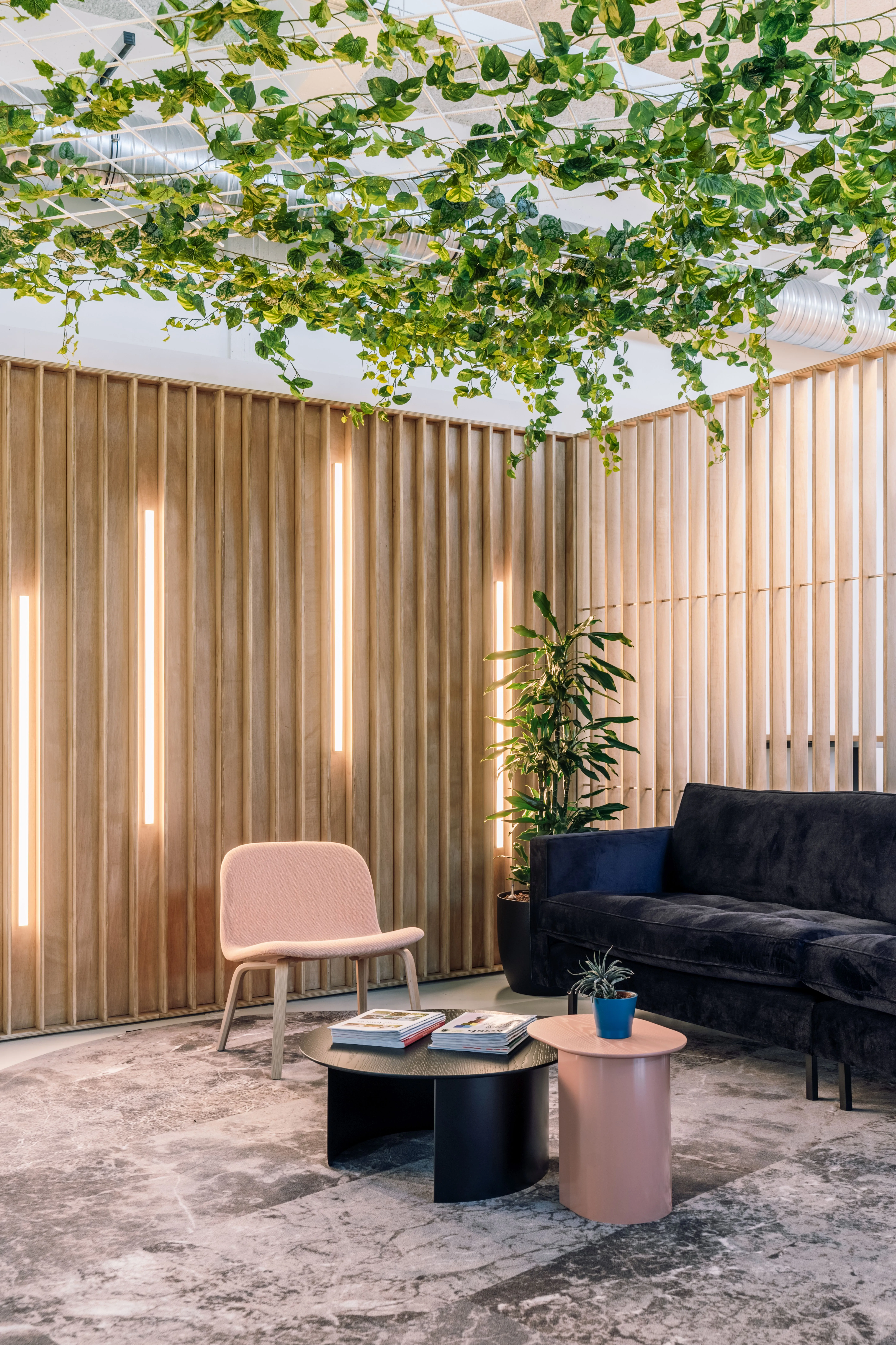 A Hockey Belgium's team member in a meeting room having a call, in the newly renovated office by Space Refinery