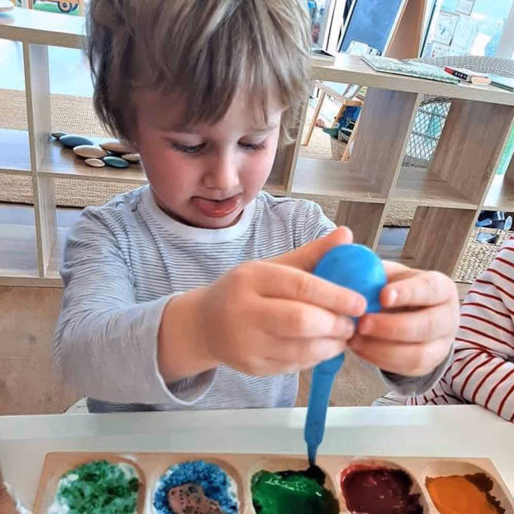 Boy experimenting with coloured paints