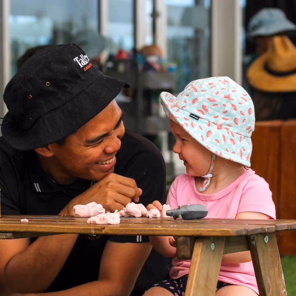 Early learning educator playing with young child