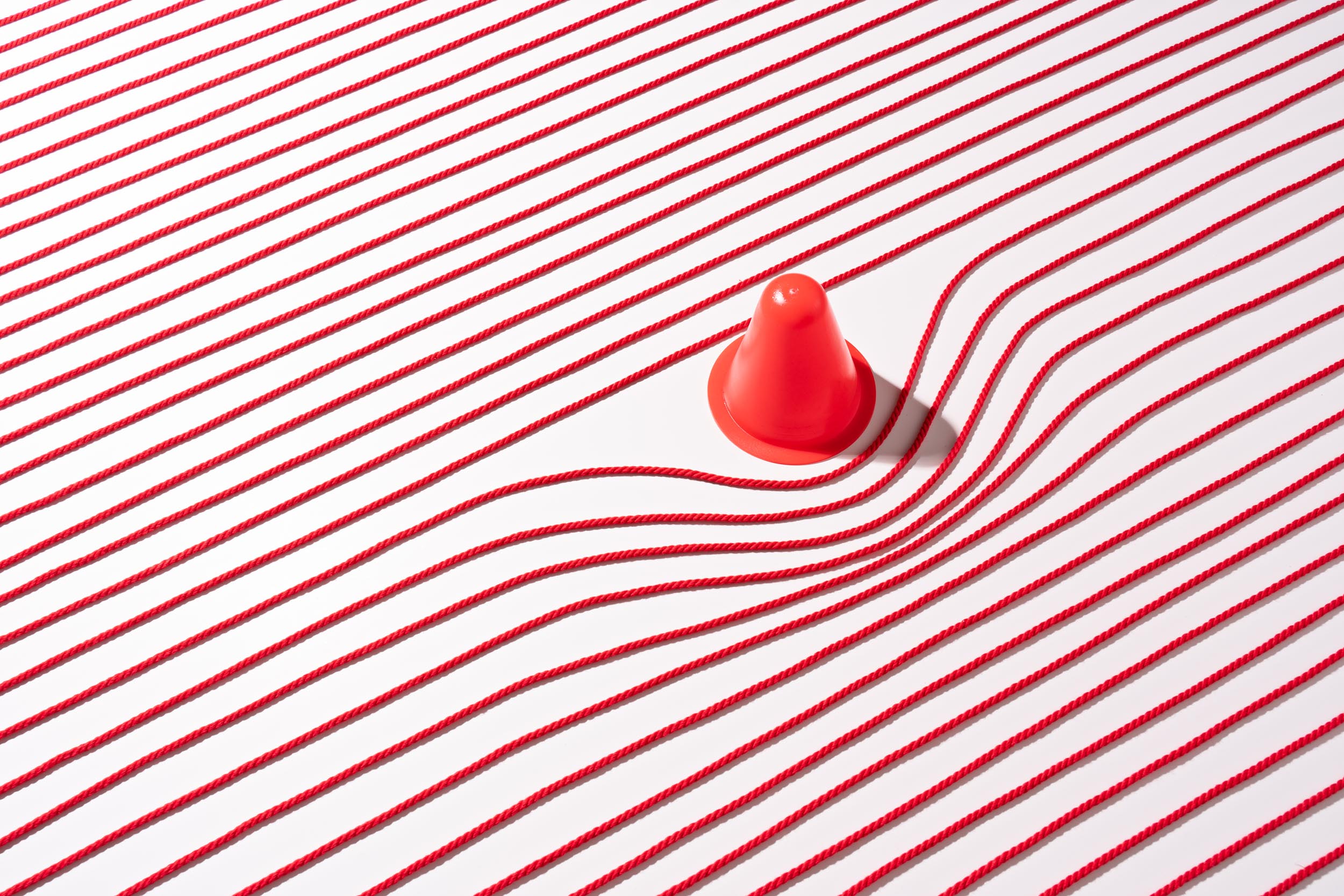 Red ropes interrupted by a cone, representing a broken sales funnel