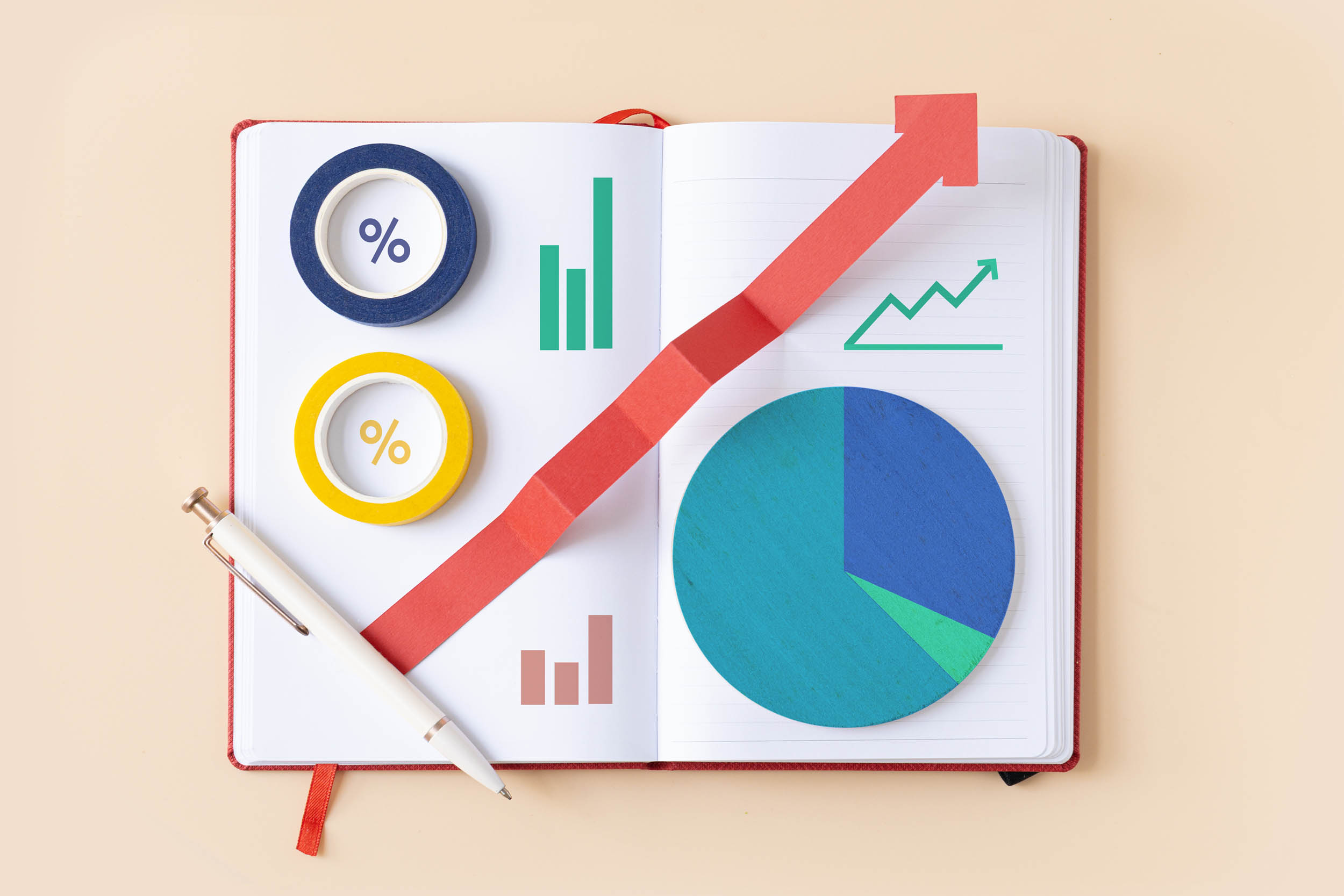 Chart and graph in a notebook representing tracking firm growth