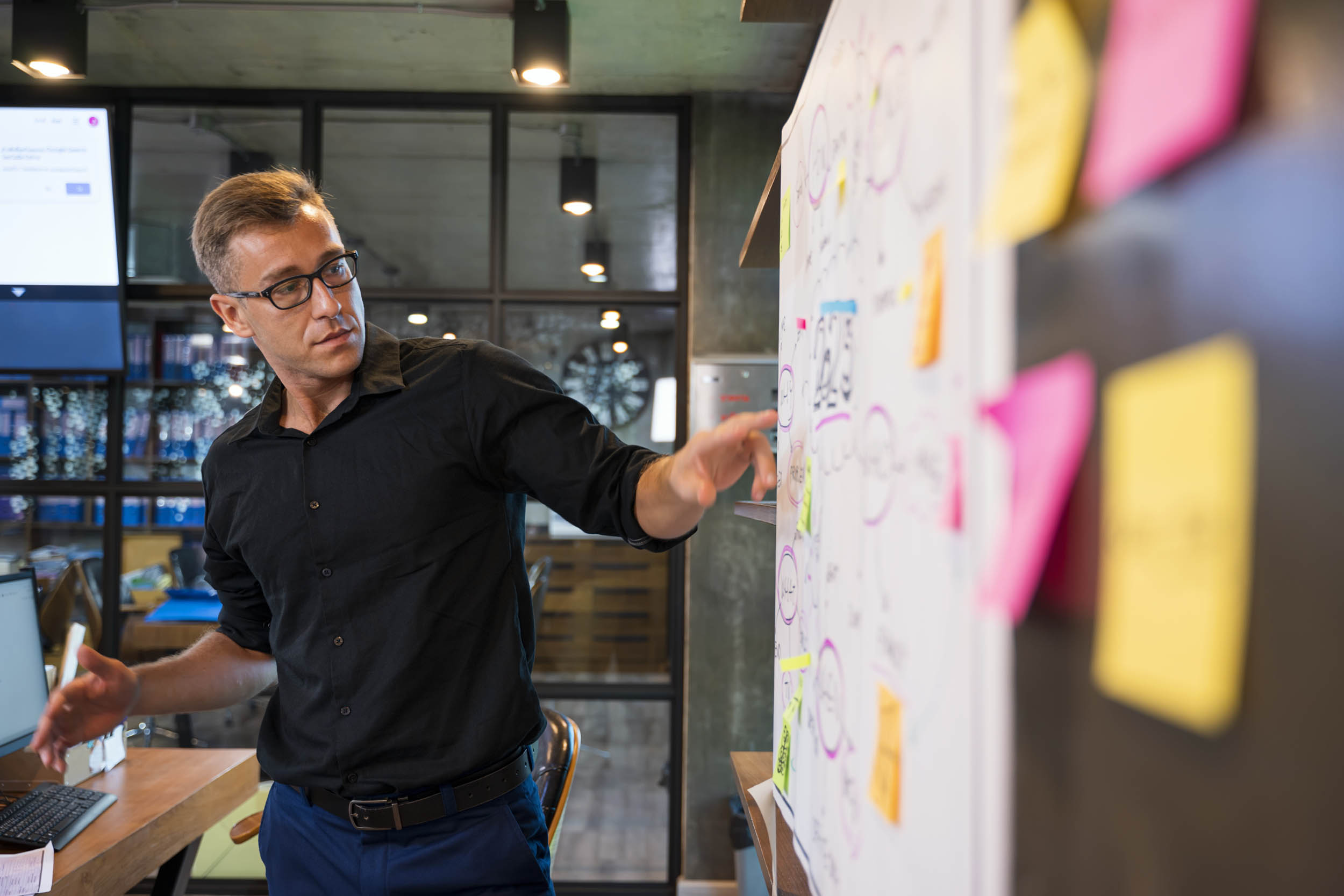 Advisor in a project meeting discussing time freed up by AI