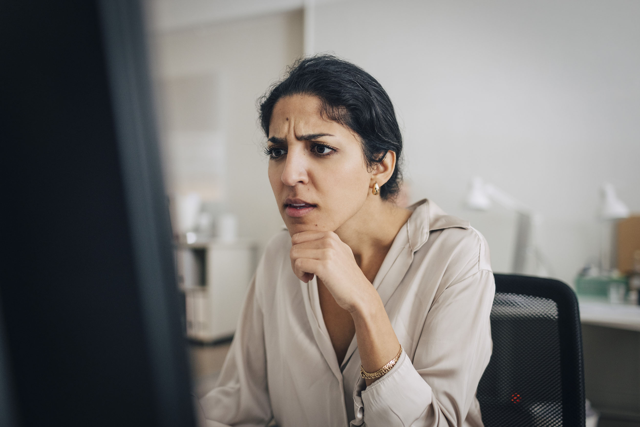 Confused person at work, representing the hidden cost of a cheap accounting firm website