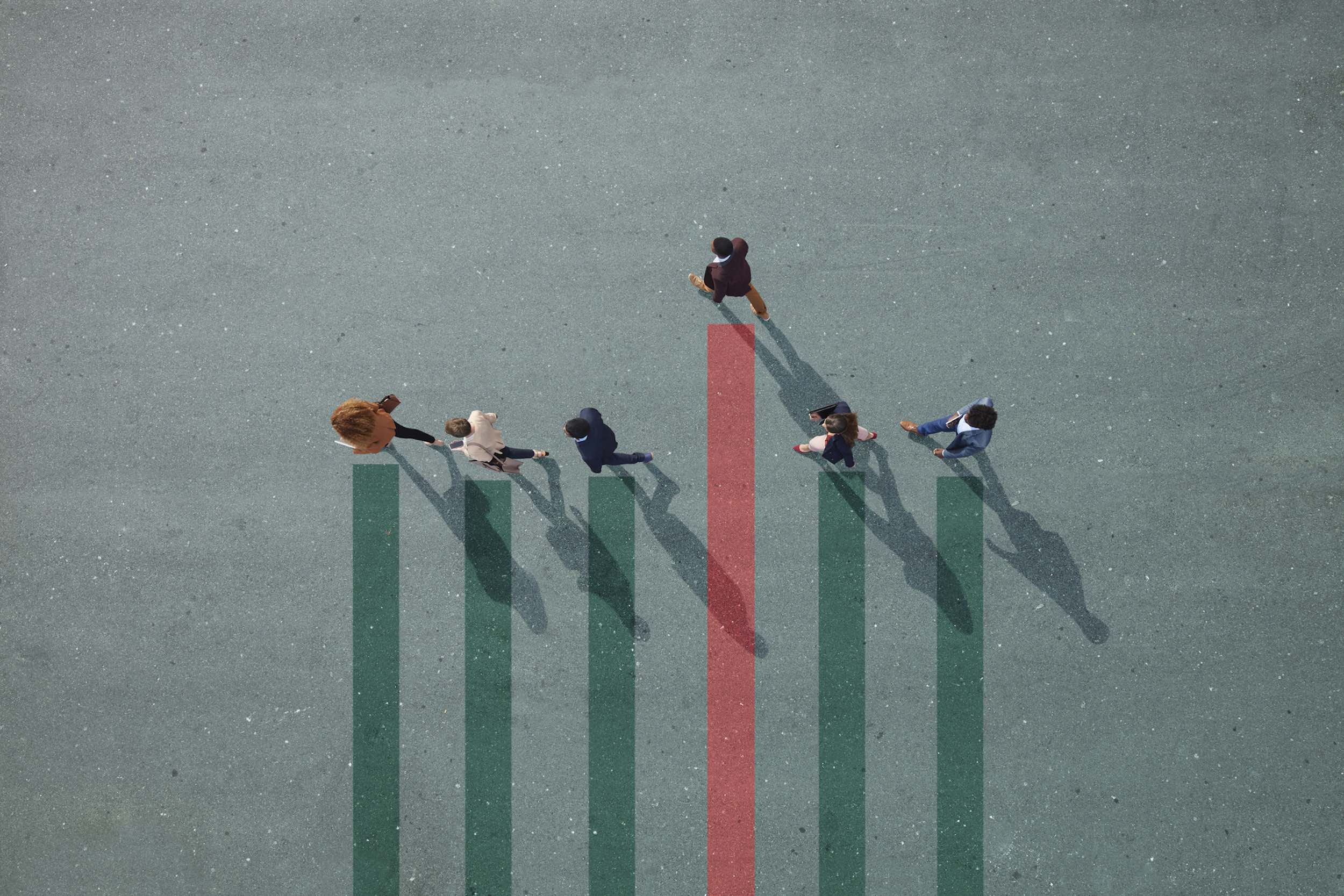 Businesspeople walking past a bar chart, representing a firm's shift to strategic influence