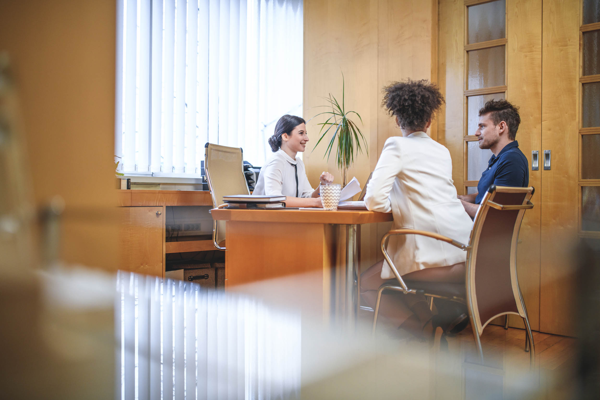 Financial advisor meeting with clients in an office