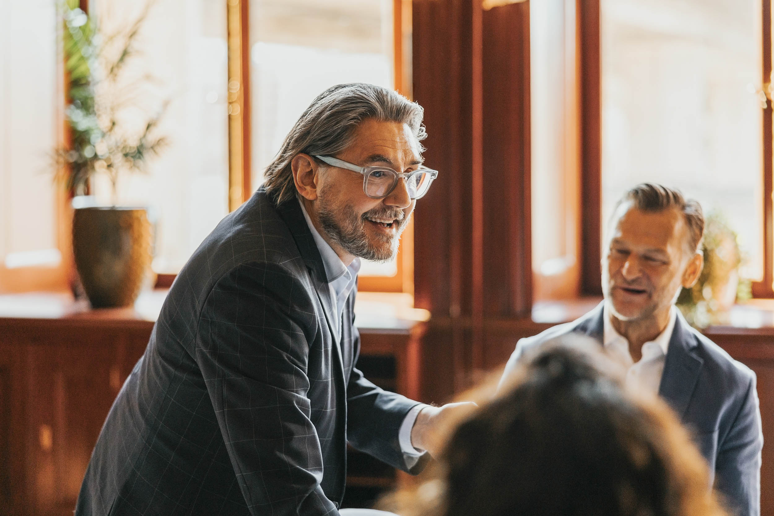 Senior professional in a business meeting, representing a small firm scaling operations