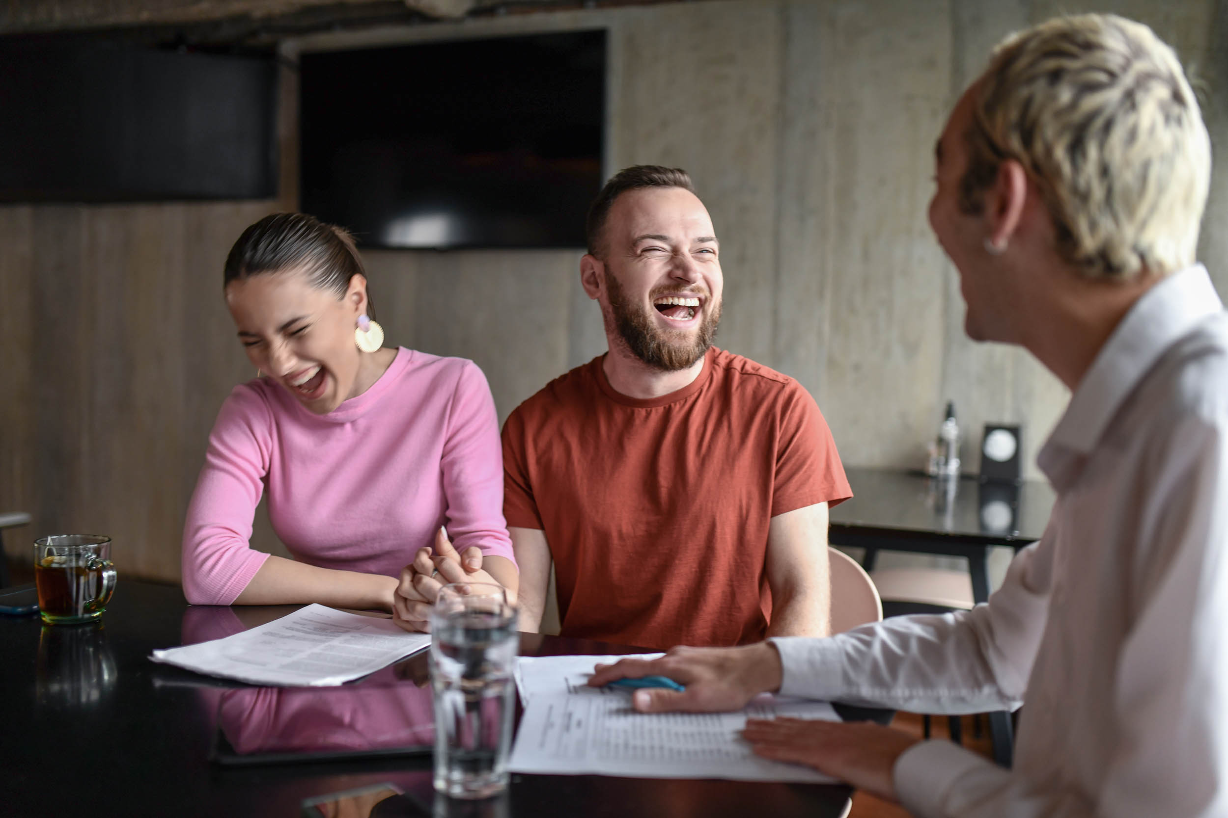 Happy client at a consultation meeting, representing the client experience layer of a firm's systems
