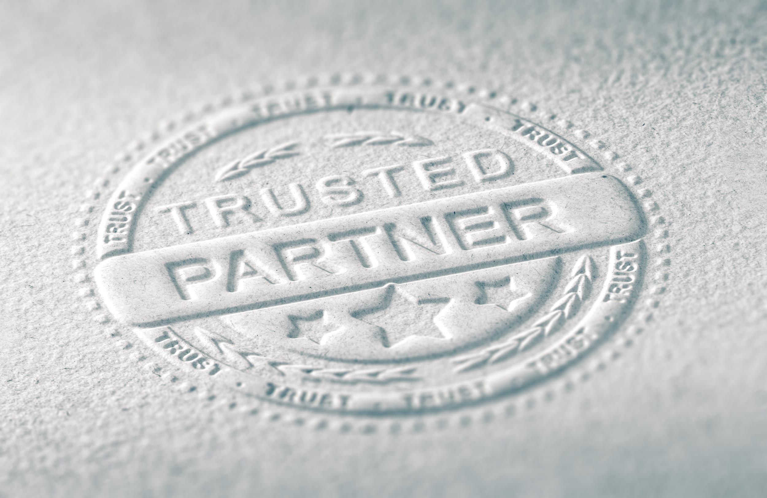 Trusted partner shaking hands, representing authentic client trust