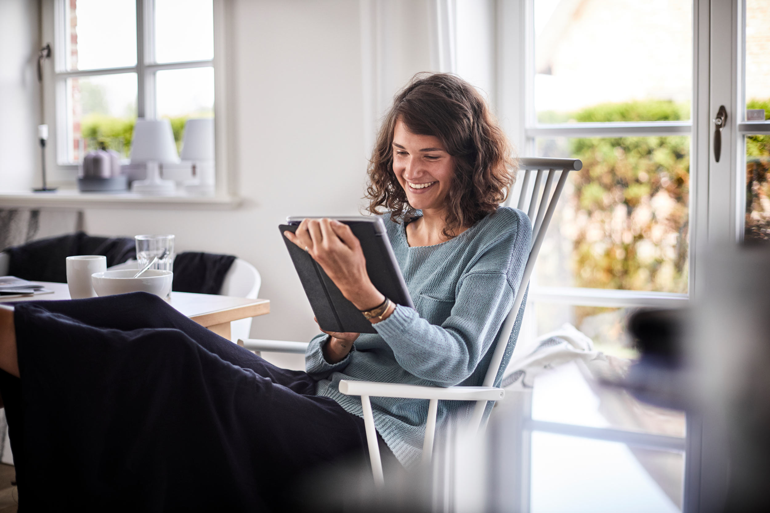 Person working on a tablet, representing AI-driven client referrals