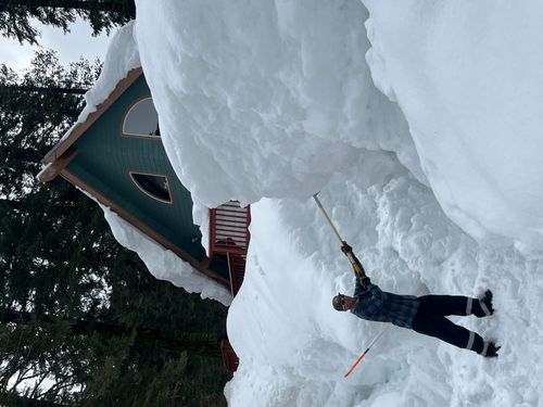 large snowbank and shovel and human