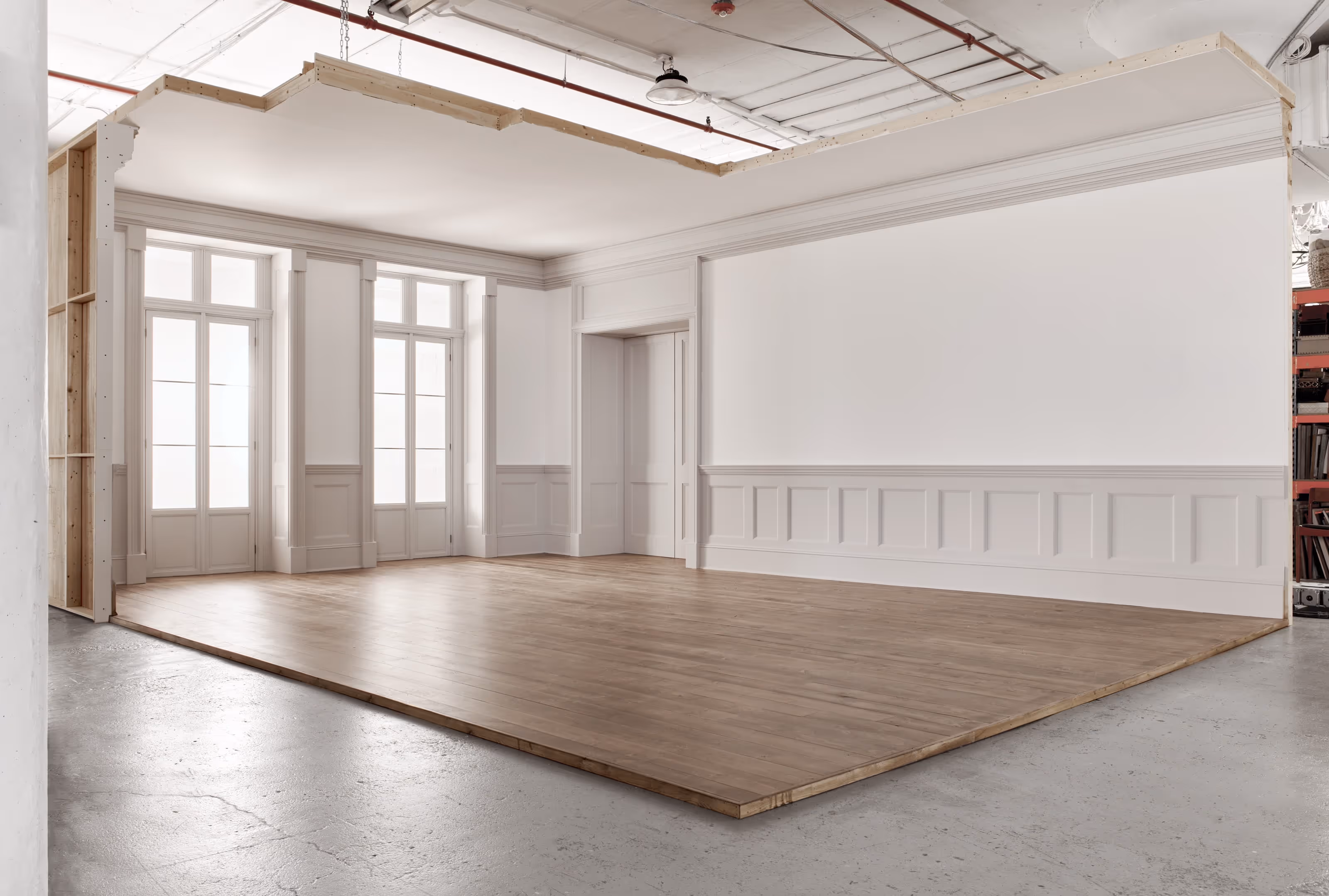 Featuring custom wood flooring, wainscoting and two working French Doors, this sophisticated interior setting evokes the timeless elegance of a historic residence. The Townhouse set was designed to accommodate the needs of photo and video productions.